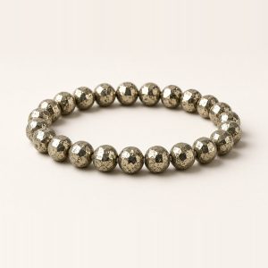 Pyrite bracelet with faceted brassy-gold metallic beads on a stretchable band
