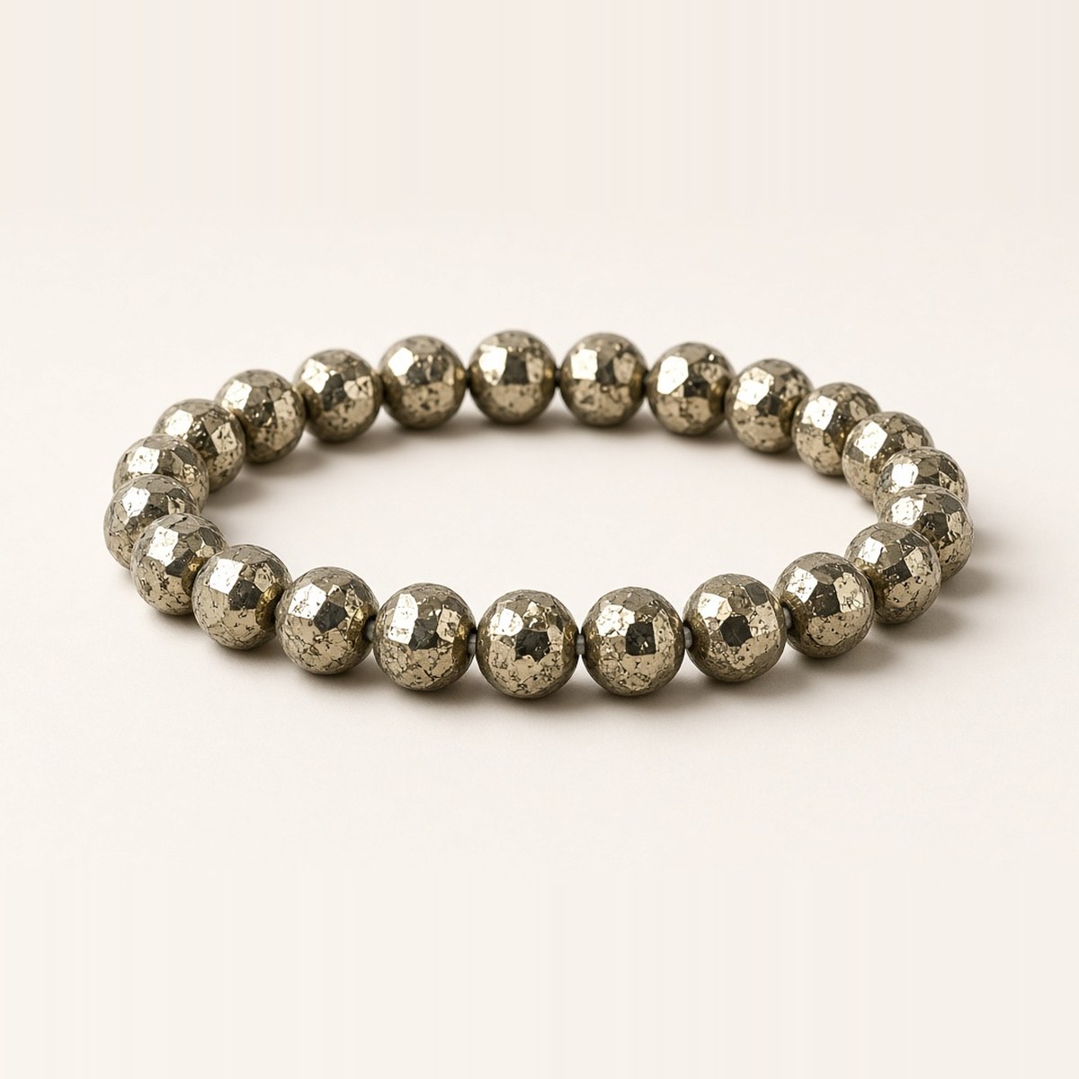 Pyrite bracelet with faceted brassy-gold metallic beads on a stretchable band