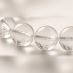 Close-up of water-clear quartz beads with natural inclusions
