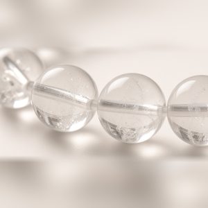 Close-up of water-clear quartz beads with natural inclusions
