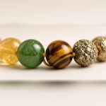 Close-up of citrine, green aventurine, tiger eye and pyrite beads