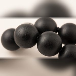 Close-up of matte black Karungali ebony wood beads