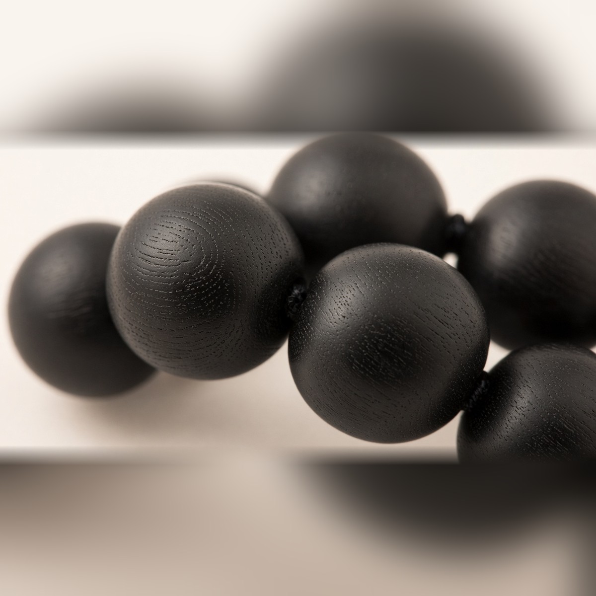 Close-up of matte black Karungali ebony wood beads