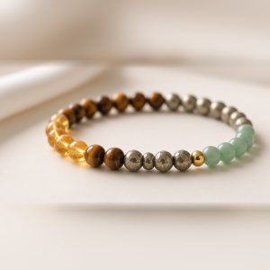Close-up of citrine, tiger eye, pyrite and green aventurine beads on Manka Money Magnet Bracelet