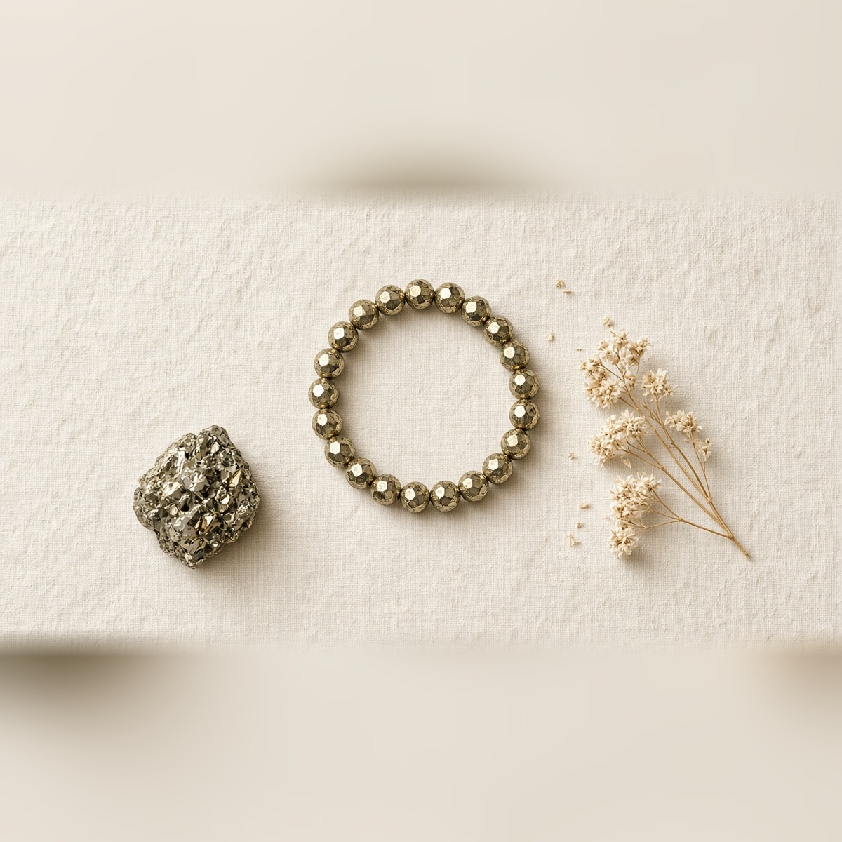 Pyrite bracelet flat lay with raw pyrite stone on linen