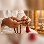 Hands holding the Manka 5 Mukhi Rudraksha Jaap Mala for mantra chanting and meditation