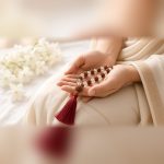 Hands holding the Manka Rudraksha & Sphatik Mala for japa and mantra chanting