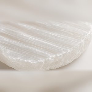 Close-up of natural selenite striations and rough-cut edge