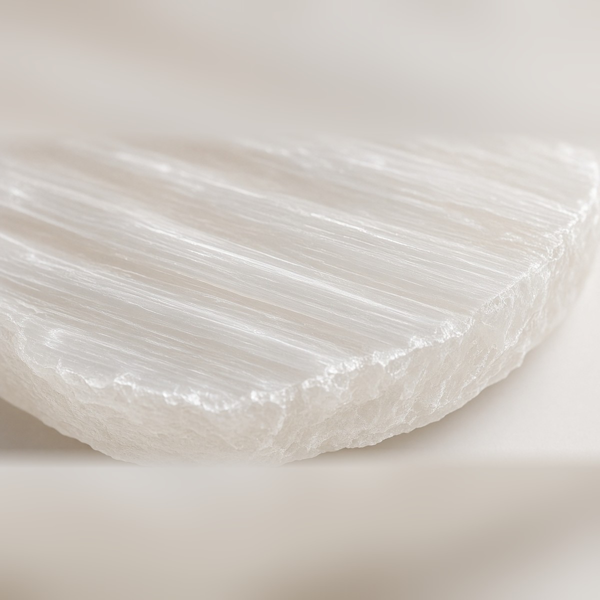 Close-up of natural selenite striations and rough-cut edge