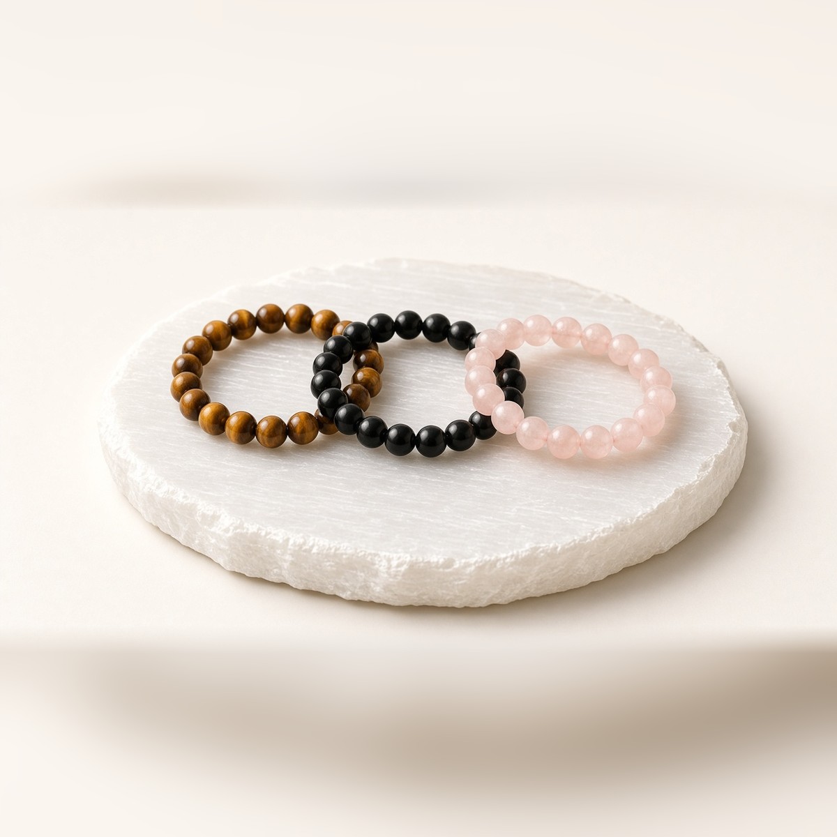 Selenite charging plate cleansing tiger eye, onyx and rose quartz bracelets